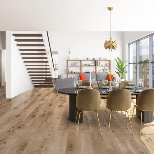 Spacious modern living room with wooden floors and large windows. Features a dining table with six chairs, a cozy sitting area, and a stylish staircase.
