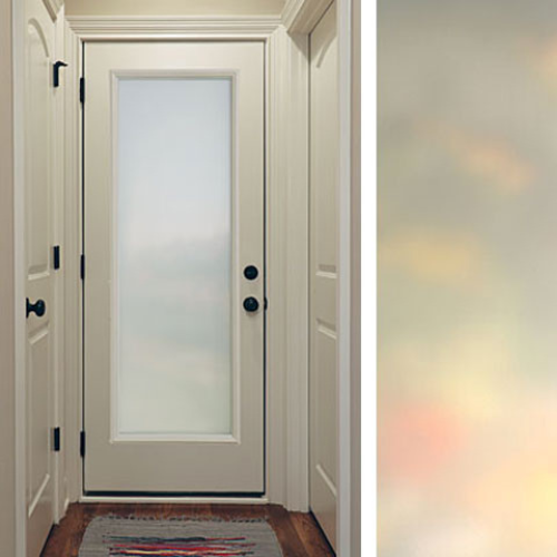 Frosted glass door in a narrow hallway with white walls and dark hardware, leading to a softly lit exterior, creating a calm and inviting atmosphere.