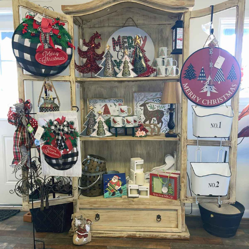 Festive wooden cabinet display filled with Christmas decor. Includes 