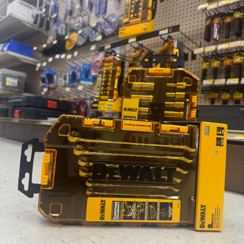 Close-up of DeWalt drill bit set with black and yellow packaging on display in a hardware store aisle, surrounded by various tools and accessories.