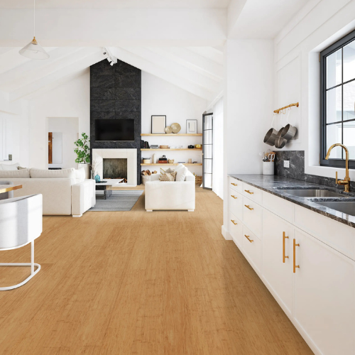 Spacious open-concept living room and kitchen with white walls, wood flooring, and black accents. Cozy seating by fireplace; modern, airy atmosphere.